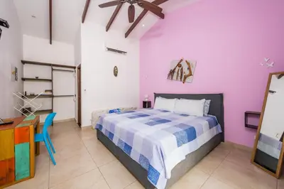 a bedroom with a bed and a desk at Surfside Mar Y Posa in Playa Flamingo