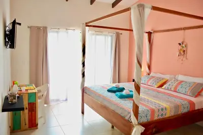 a bedroom with a bed with a canopy at Surfside Mar Y Posa in Playa Flamingo
