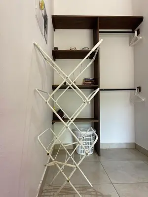 a shelf in a kitchen next to a refrigerator at Surfside Mar Y Posa in Playa Flamingo