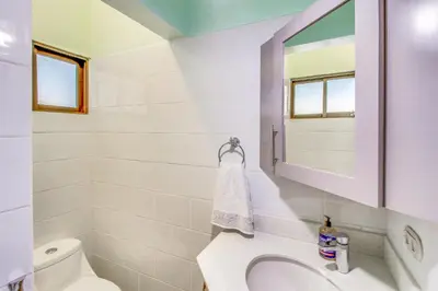 a bathroom with a toilet and a sink and a mirror at Aquamarine 4 in Guanacaste