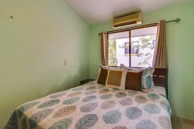 a bedroom with a bed and a window at Aquamarine 4 in Guanacaste