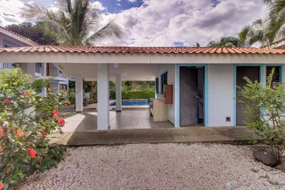 a white house with a porch and a courtyard at Aquamarine 4 in Guanacaste