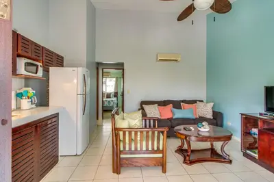 a kitchen and a living room with a couch and a table at Aquamarine 4 in Guanacaste