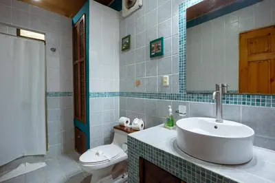a bathroom with a sink and a toilet at Boutique Hotel Las Cascadas in Manuel Antonio