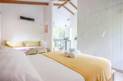 a bedroom with a bed with towels on it at Boho lodge Montezuma l&l in Montezuma