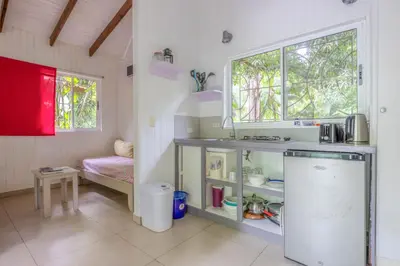 a small kitchen with a sink and a window at Boho lodge Montezuma l&l in Montezuma