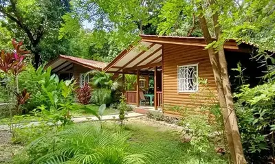 a small wooden cabin in the middle of a garden at Boho lodge Montezuma l&l in Montezuma