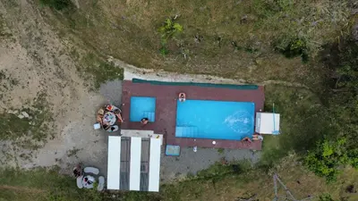 an overhead view of a pool with people around it at La Flor de Loto in Cartago