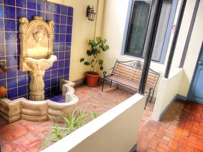 a porch with a faucet and a bench at Hotel Santo Tomas / Historical Property in San José