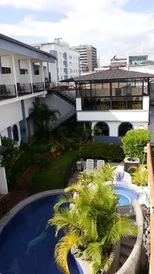 a view of a resort with a pool and palm trees at Hotel Santo Tomas / Historical Property in San José