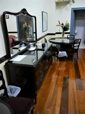 a dresser with a mirror and a table in a room at Hotel Santo Tomas / Historical Property in San José