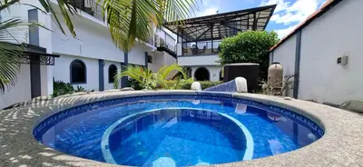 a swimming pool in front of a building at Hotel Santo Tomas / Historical Property in San José