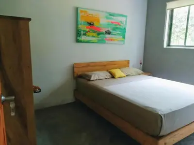 a bedroom with a bed in a room at Shakti in Santa Teresa Beach