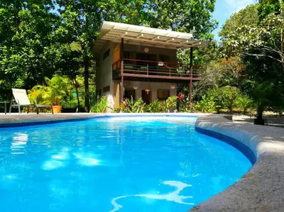 a swimming pool in front of a house at Shakti in Santa Teresa Beach