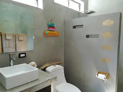 a bathroom with a white sink and a toilet at Shakti in Santa Teresa Beach