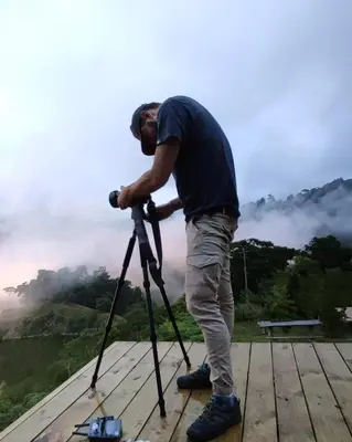 a man holding a camera on a tripod at EYA Ecolodge in San Isidro
