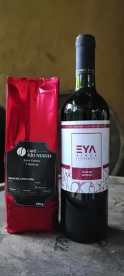 a bottle of wine sitting next to a red bag at EYA Ecolodge in San Isidro