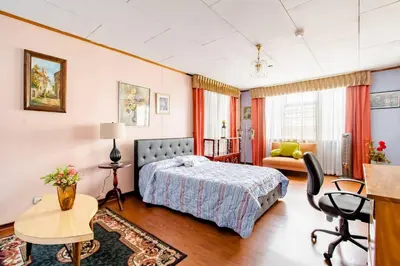 a bedroom with a bed and a desk at Vilma Friendly Guesthouse - RA in San José