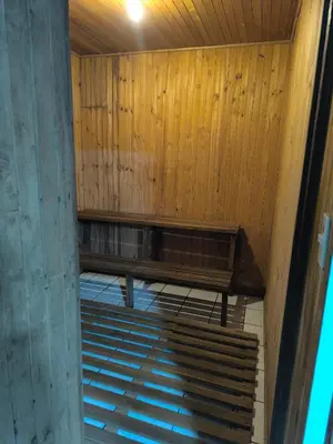 an empty room with wooden walls and wooden stairs at Vilma Friendly Guesthouse - RA in San José