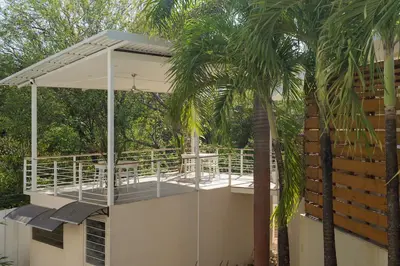 a porch with a white canopy on top of a house at BOHO Tamarindo in Tamarindo