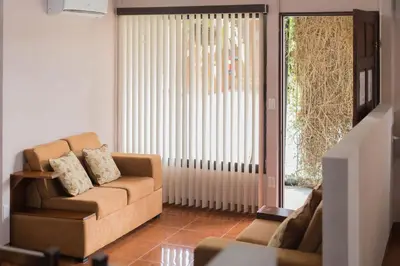 a living room with a couch and a window at Cabañas del Rio in Fortuna