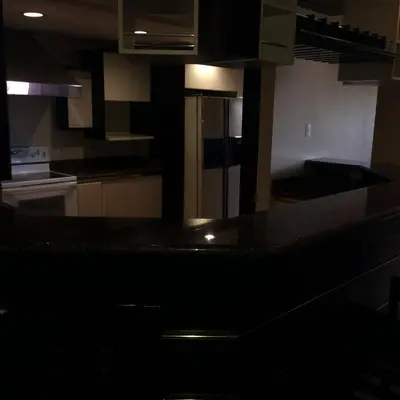 a kitchen with a counter top and a refrigerator at Hotel La Amistad in San José