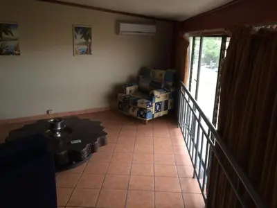 a living room with boxes on a tiled floor at Hotel La Amistad in San José