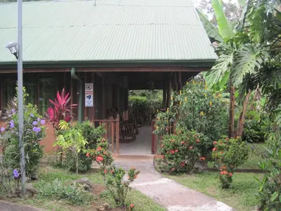 a building with a green roof with flowers and plants at Chalet Villa Vilma in San Mateo