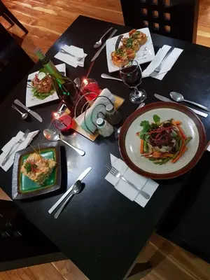 a table with plates of food and glasses of wine at Hotel Castillo in San José