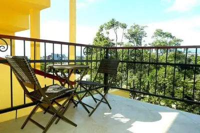 two chairs and a table on a balcony at Hotel Castillo in San José