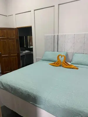 a bedroom with a bed with an orange ribbon on it at Gallina E Palo Beachfront Hotel in Jacó