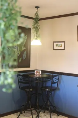 a bar with two chairs and a table at Berlor Airport Inn in Alajuela City