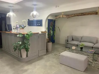 a living room with a couch and a table at Berlor Airport Inn in Alajuela City