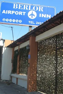 a sign for a abortion airport in front of a building at Berlor Airport Inn in Alajuela City