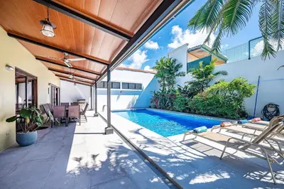 a swimming pool in the backyard of a house at Casa Gris with private pool near the beach in Jaco in Jacó