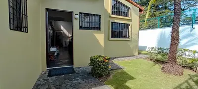 a front door of a house with a plant at Casa Gris with private pool near the beach in Jaco in Jacó