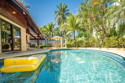 a swimming pool with a yellow raft in a house at Casa Mandolina on the beach in Jaco in Jacó