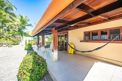 a porch of a house with a house at Casa Mandolina on the beach in Jaco in Jacó