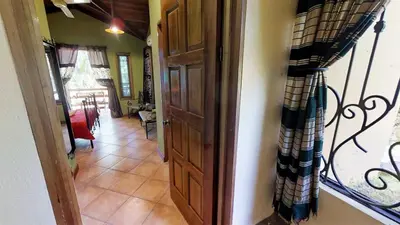 a hallway with a staircase leading to a living room at Quinta Teca with two pools near Playa Hermosa beach in Playa Hermosa