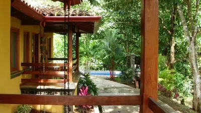 a porch of a house with a view of a garden at Quinta Teca with two pools near Playa Hermosa beach in Playa Hermosa
