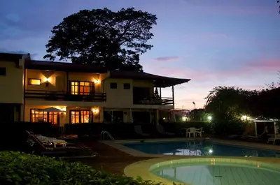 a house with a swimming pool at night at Rio Copey 2 townhouse near the beach in Jaco in Jacó