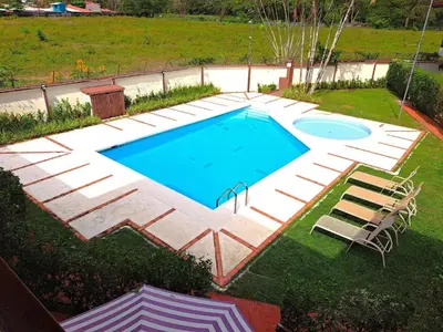 an overhead view of a swimming pool with a patio and chairs at Rio Copey 2 townhouse near the beach in Jaco in Jacó