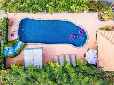 an overhead view of a swimming pool with an umbrella at Villa Jaco Sol 4 bdr resort pool near the beach in Jacó