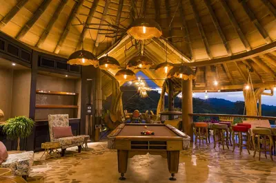 a pool table in a room with a view at Origins Lodge in Bijagua