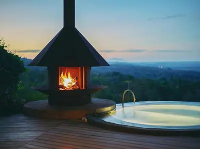 a lantern with a fire next to a hot tub at Origins Lodge in Bijagua