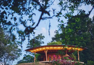 a wooden pergola with plants on top of a hill at Origins Lodge in Bijagua