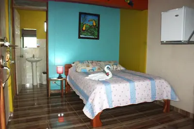 a bedroom with a bed in a room at Cabinas Cascada Rio Celeste in Bijagua