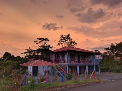 a building with a playground in front of it at Cabinas Cascada Rio Celeste in Bijagua