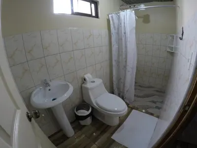 a bathroom with a sink and a toilet and a shower at Cabinas Cascada Rio Celeste in Bijagua