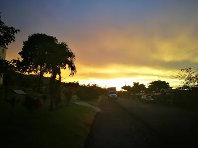 a van driving down a street at sunset at Hospedaje Las Orquídeas in Venecia